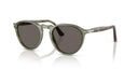 Green sunglasses with dark lenses on a white background