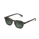 Sunglasses with dark frames and green lenses on a white background