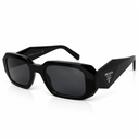 Side angle of black sunglasses with black tinted lenses on a white background. 