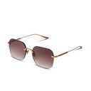 Sunglasses with gold frame and gradient lenses on a white background