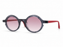 Sunglasses with round frame, pink lenses, and red accents on a white background