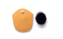 Beige pouch and round clip on on a white background. 
