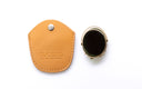 A tan leather protective case, shown next to the clip on, which has a gold-toned metal frame and a dark screen. The leather case features a snap button closure and the brand name 'DUCISUX' embossed on it, set against a clean white background.