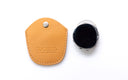 A tan leather protective case, shown next to a black clip on, on a clean white background. The case features a snap button closure and the brand name 'DUCLOUX' embossed on the front.