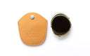 Round clip on with a dark tinted lens and gold-tone metal frame, shown next to their tan leather protective case embossed with the brand name 'Ducloux'.