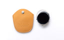 A light tan leather protective case, shown next to a silver clip on with dark lenses with a black screen, on a clean white background. The leather case features a snap button and the debossed brand name 'DUCLOUX'.