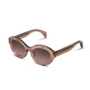 Champagne colored sunglasses with gradient lenses on a white background