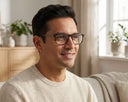 A man wearing a pair of tortoiseshell eyeglasses