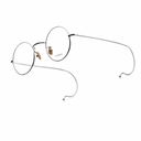Side angle of round silver eyeglasses on a white background.