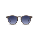 Round sunglasses with a translucent taupe-grey frame and dark blue gradient lenses, shown against a plain white background.