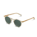 Round sunglasses with translucent off-white frames, gold metal rims, and dark green lenses, shown on a clean white background.