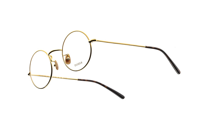 Gold and black eyeglasses on a white background