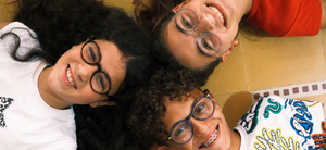 Three people wearing glasses lying on the floor with 3 different glasses : OV offer (50% off new glasses lenses)