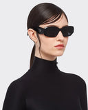 Side angle of a girl wearing black sunglasses on a white background. 